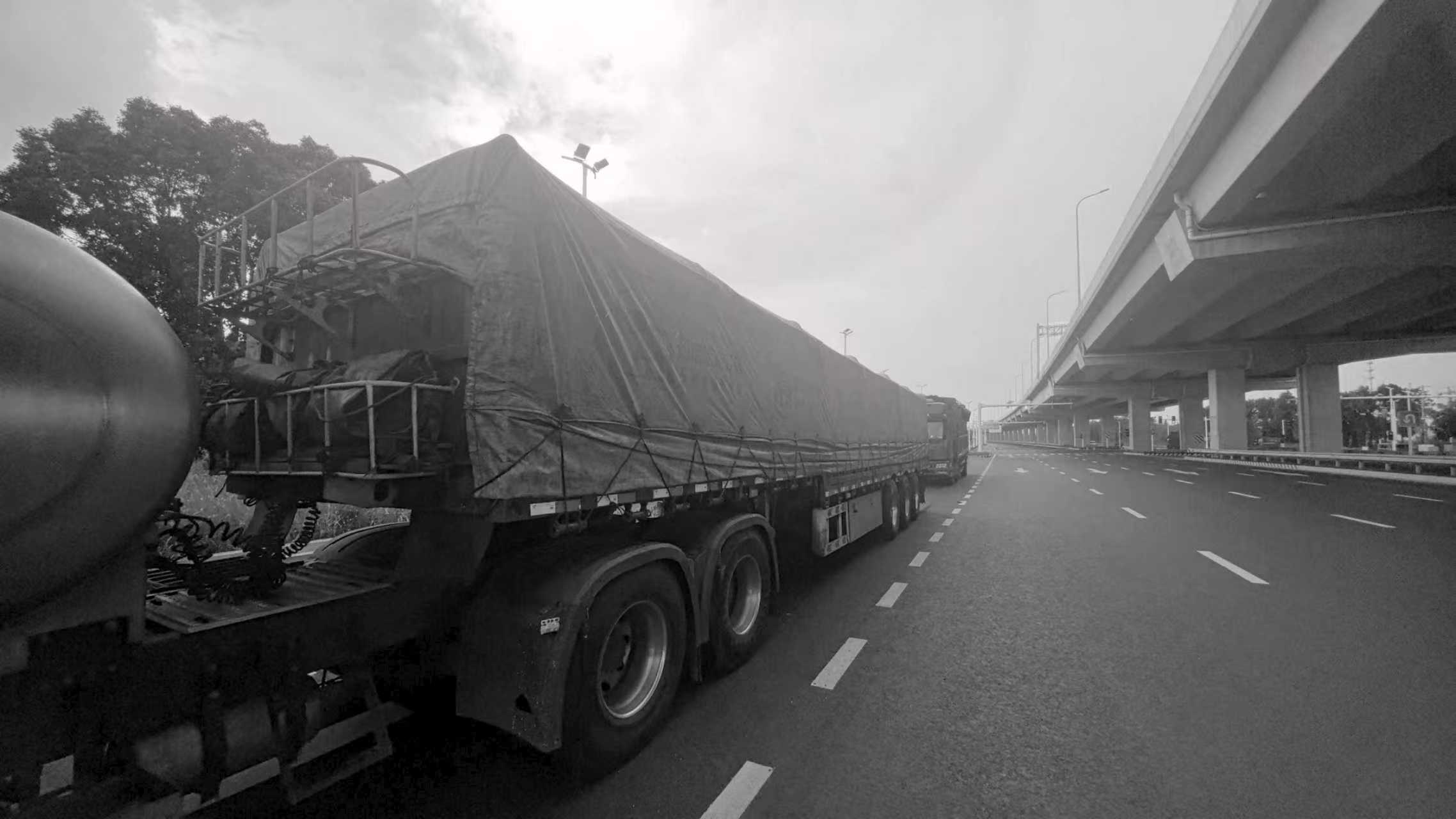 Sheeted project cargo trailer in transit on the highway
